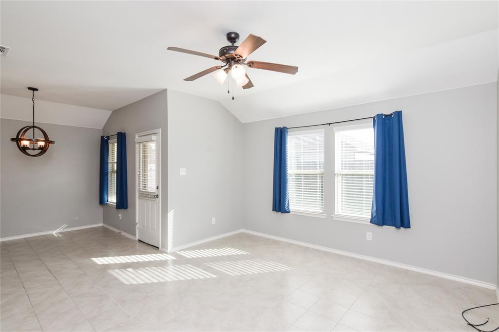 1406 Slate Street Princeton, TX 75407 - Photo 7 of 25 a view of an empty room with window and chandelier fan