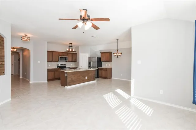 a view of kitchen with cabinets microwave and refrigerator