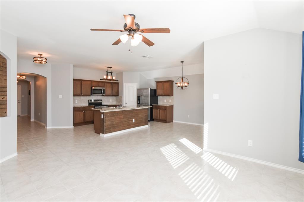 1406 Slate Street Princeton, TX 75407 - Photo 8 of 25 a view of kitchen with cabinets microwave and refrigerator