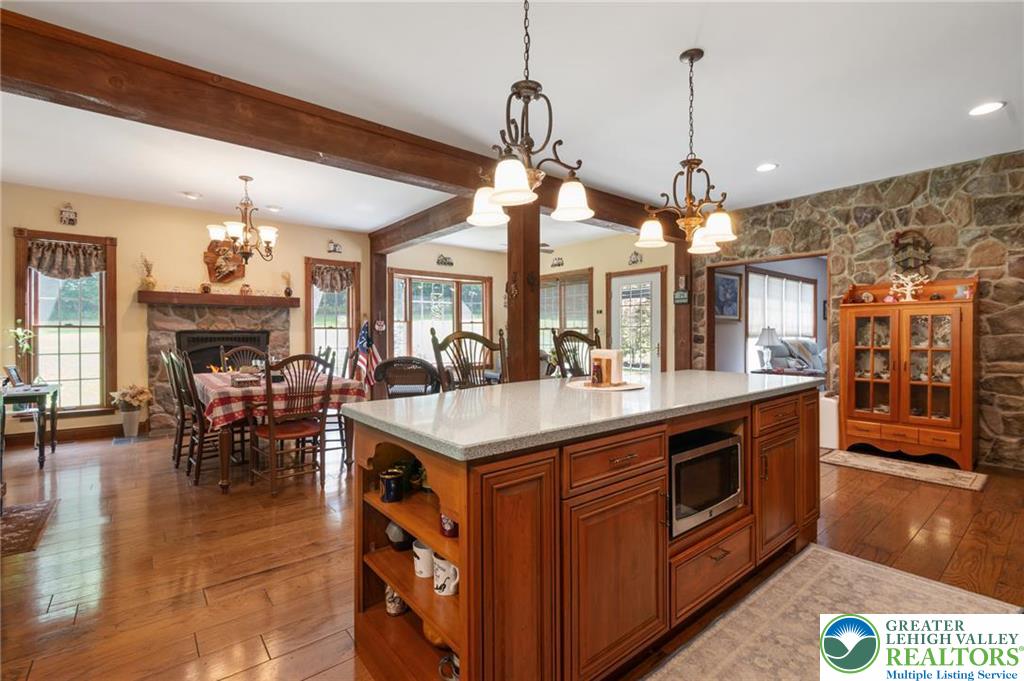 1222 Spring Road Andreas, PA 18211 - Photo 7 of 44 Rich wood beams, a stone accent
wall, and polished floors anchor this
open concept layout.