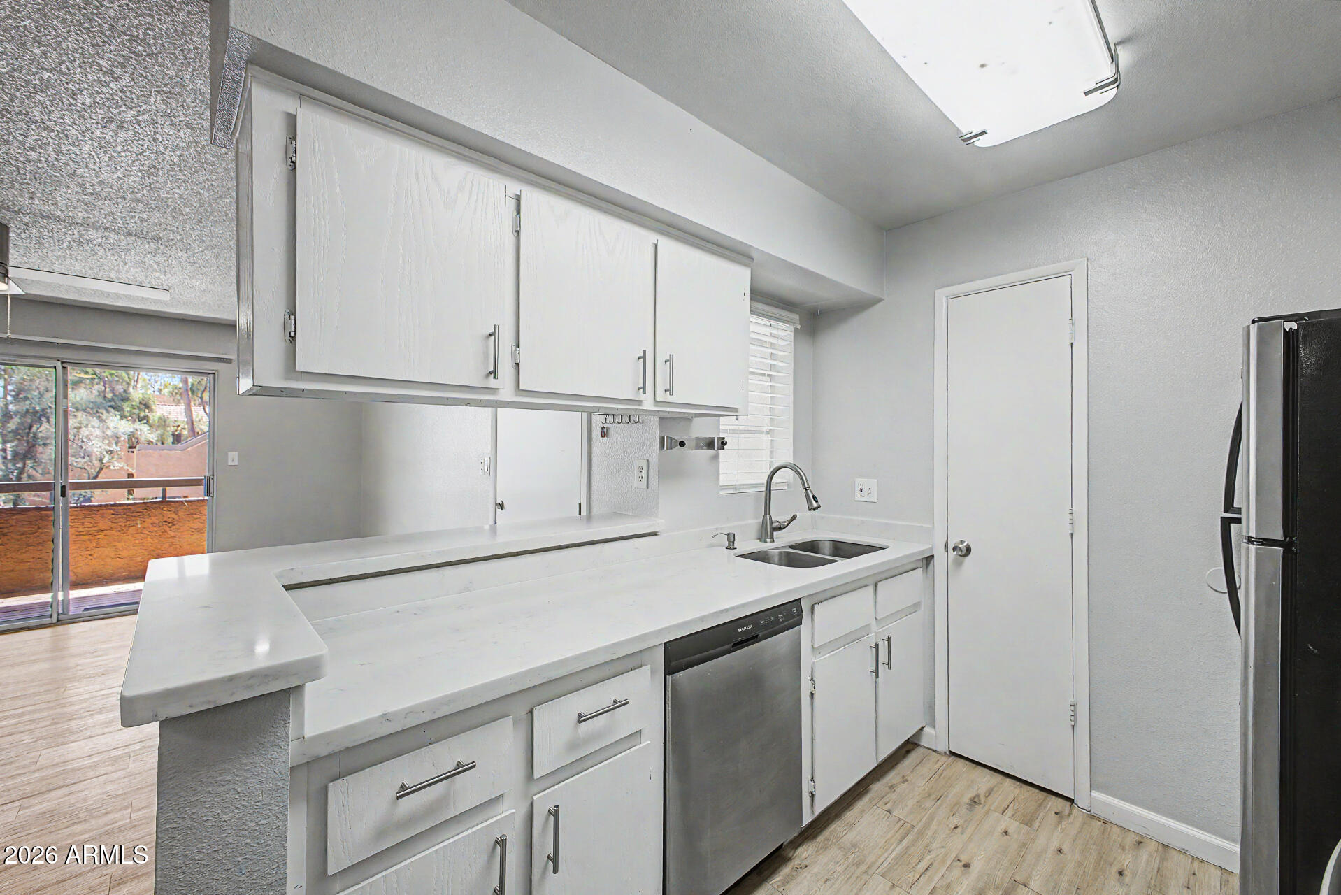 2625 East Indian School Road, Unit 227 Phoenix, AZ 85016 - Photo 4 of 31 a kitchen with a sink appliances and cabinets
