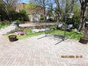 a view of backyard with table and chairs plants and trees