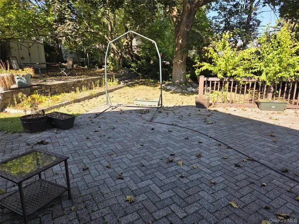 a view of swimming pool with lawn chairs and plants