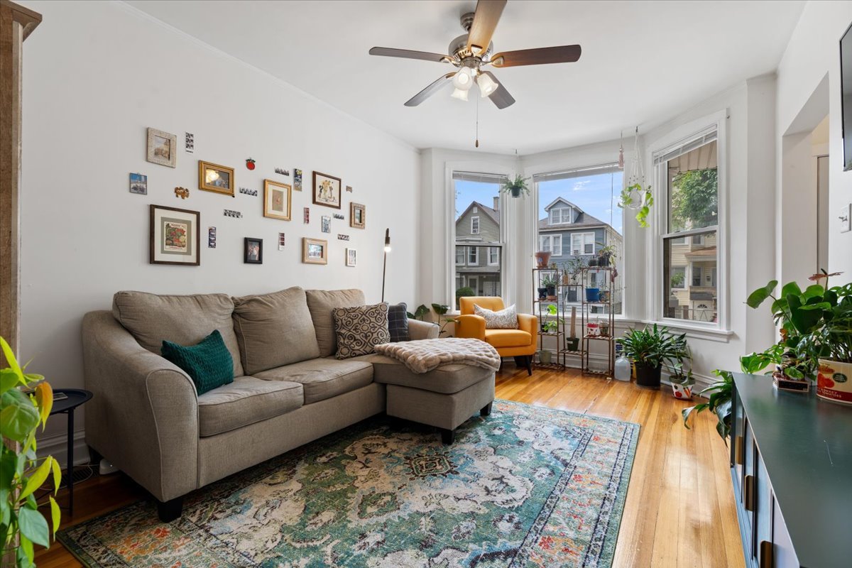2735 North Ridgeway Avenue Chicago, IL 60647 - Photo 20 of 40 a living room with furniture ceiling fan and a rug