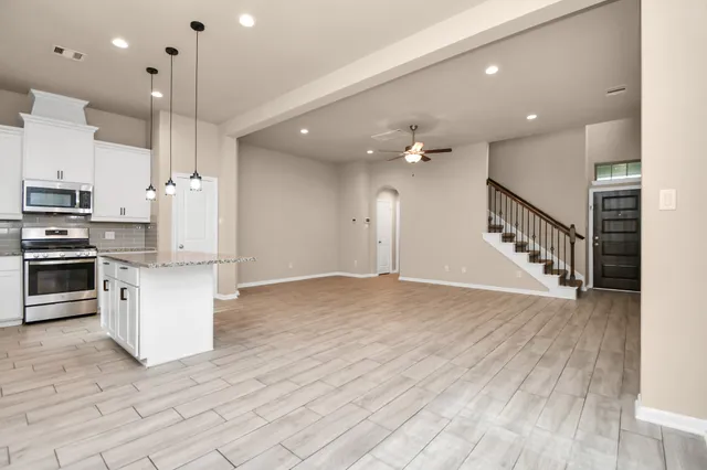a view of a kitchen with a granite countertop sink and refrigerator
