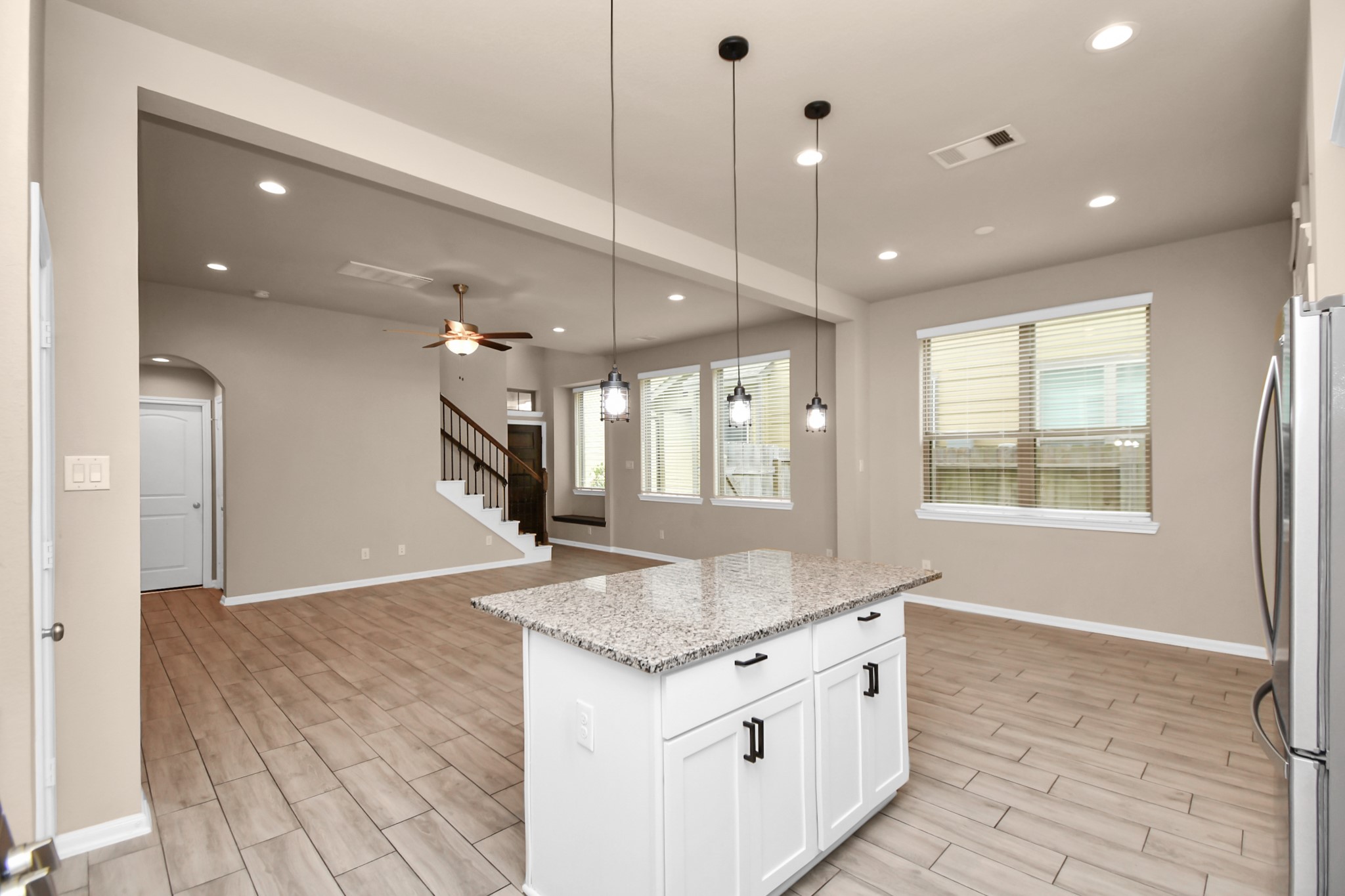 4220 Merry Mill Drive Spring, TX 77386 - Photo 15 of 44 a hall with kitchen island granite countertop a sink and a stove