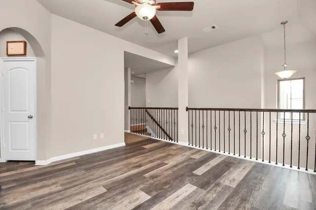a view of a livingroom with a fan and a window