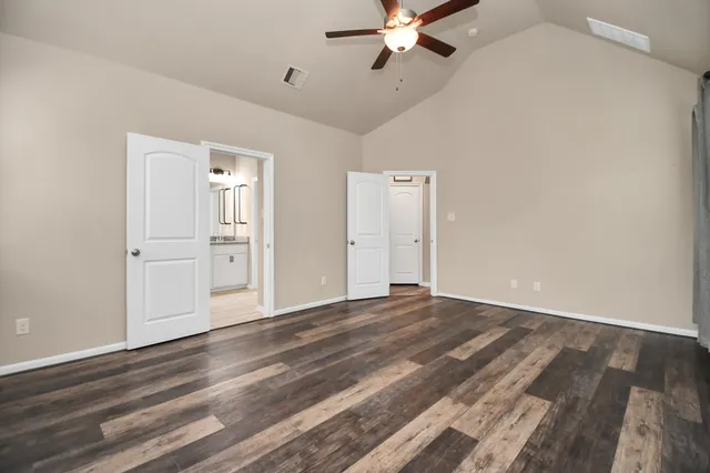 a bathroom with a granite countertop bathtub a sink and a large mirror