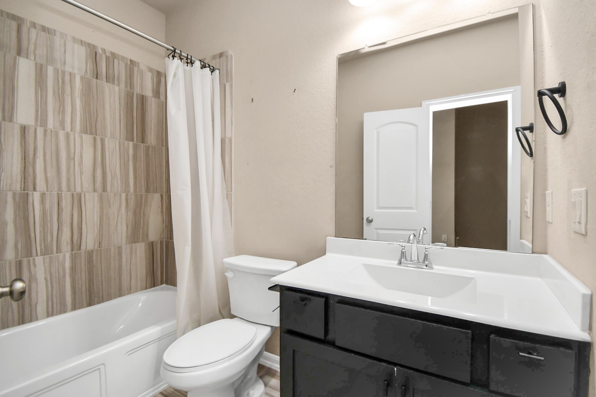 4220 Merry Mill Drive Spring, TX 77386 - Photo 34 of 44 a bathroom with a sink a toilet and shower curtain