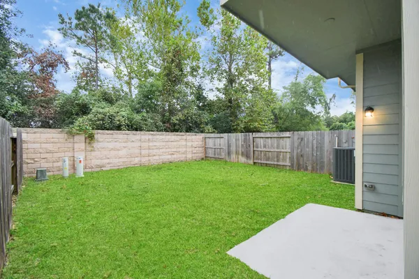 a view of a backyard with a garden and entertaining space
