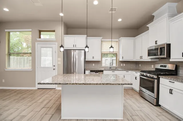 a view of a kitchen with a sink and a window