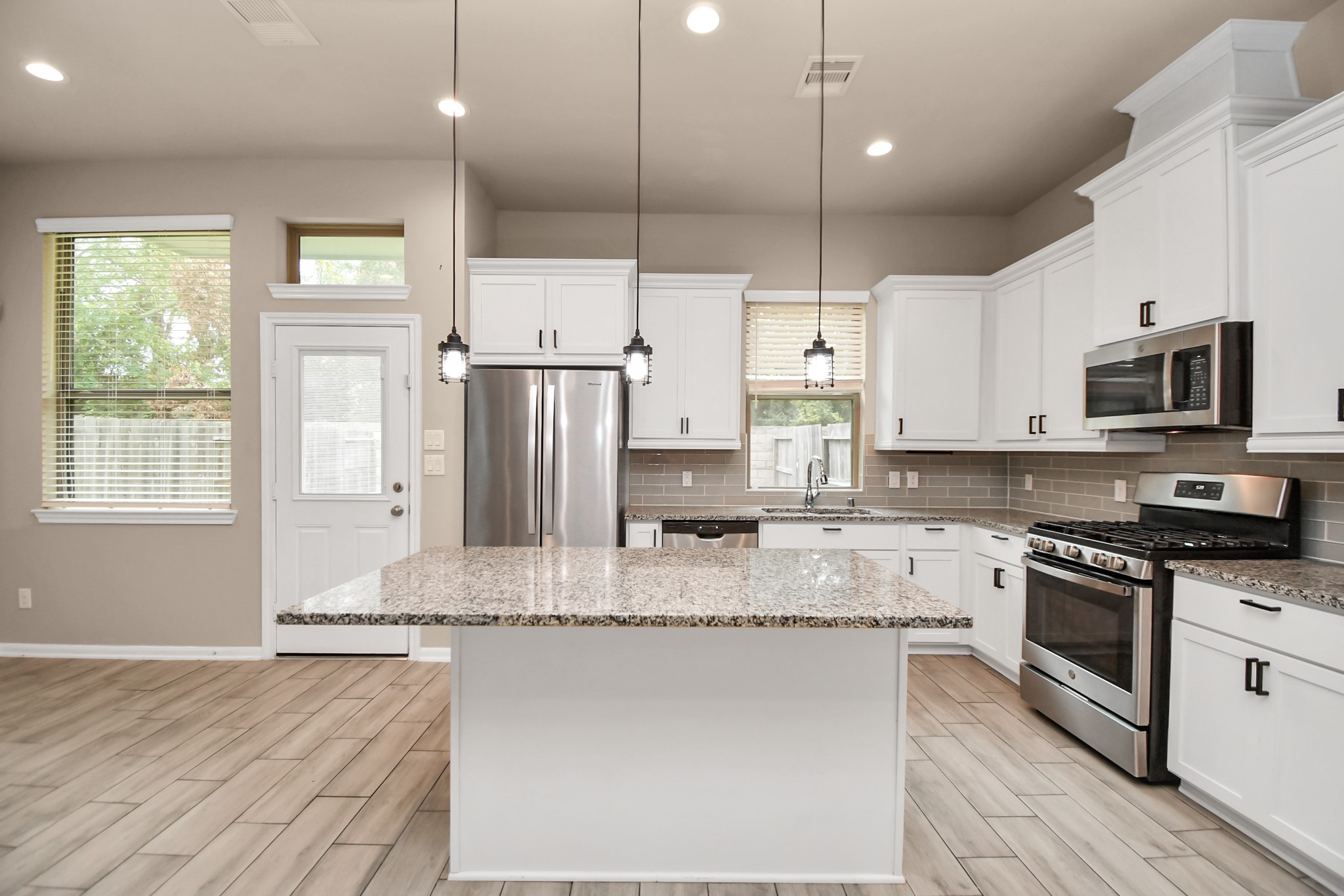 4220 Merry Mill Drive Spring, TX 77386 - Photo 6 of 44 a large kitchen with stainless steel appliances granite countertop a stove a sink and a refrigerator