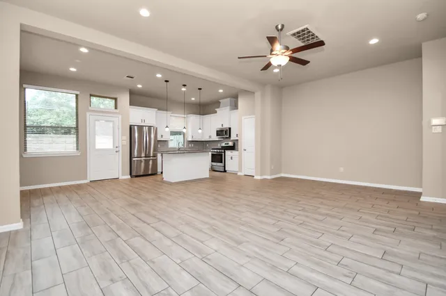 a kitchen with stainless steel appliances granite countertop a refrigerator sink and stove