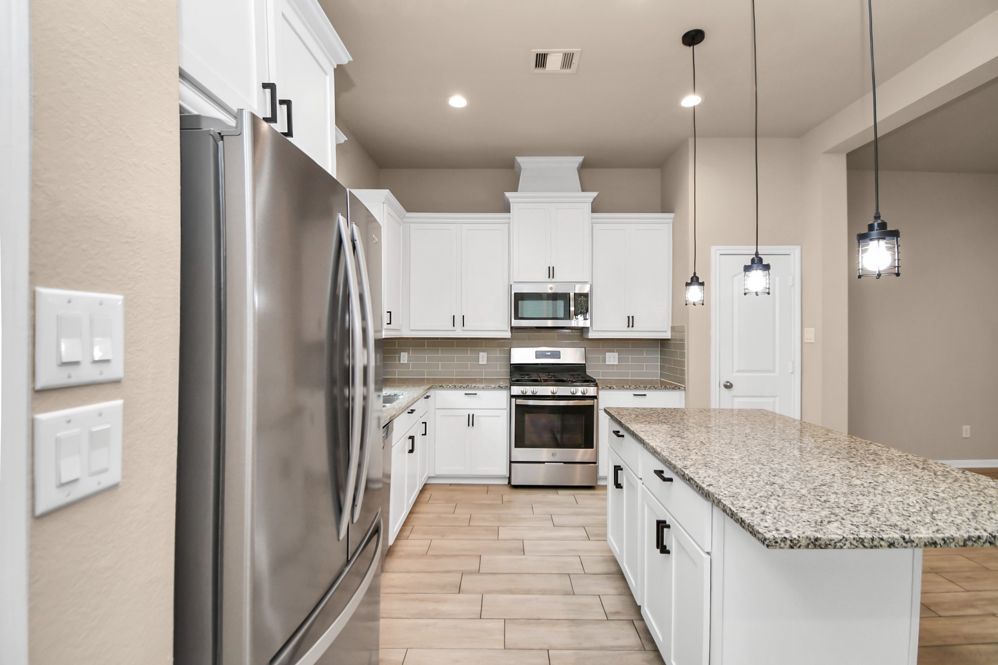 4220 Merry Mill Drive Spring, TX 77386 - Photo 9 of 44 a large kitchen with stainless steel appliances granite countertop a refrigerator and a sink