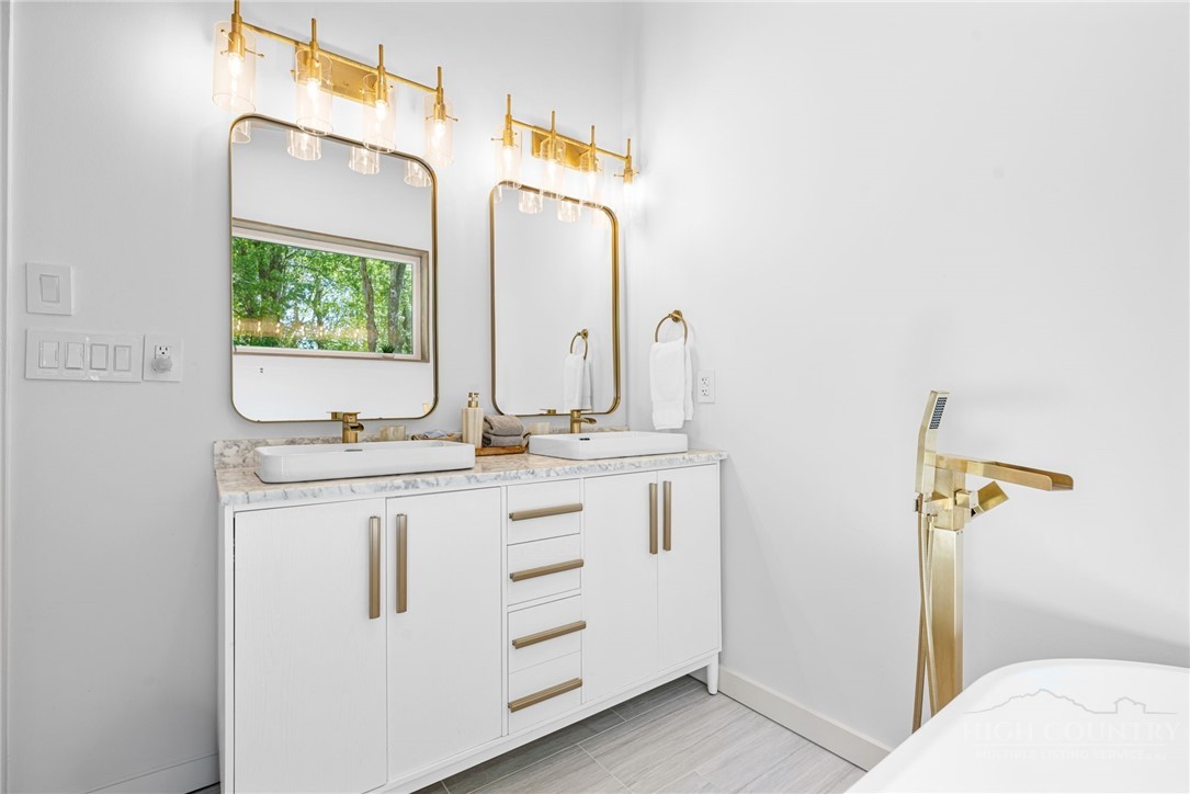 1385 Niley Cook Road Blowing Rock, NC 28605 - Photo 24 of 40 a bathroom with a sink and a mirror