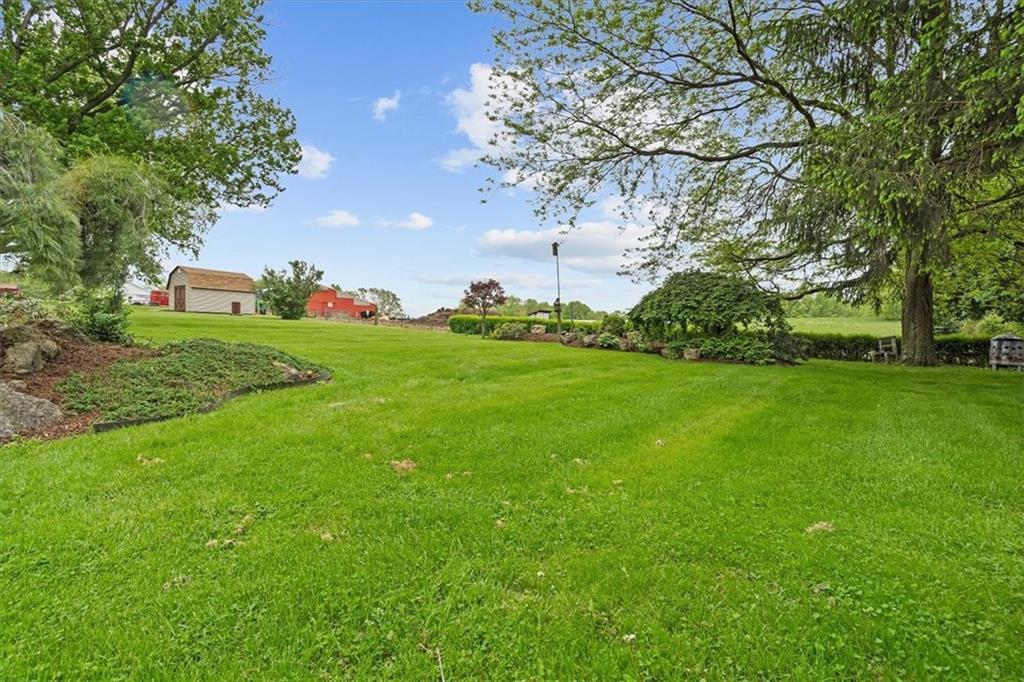 726 Winfield Road Cabot, PA 16023 - Photo 23 of 25 a backyard of a house with lots of green space and fountain