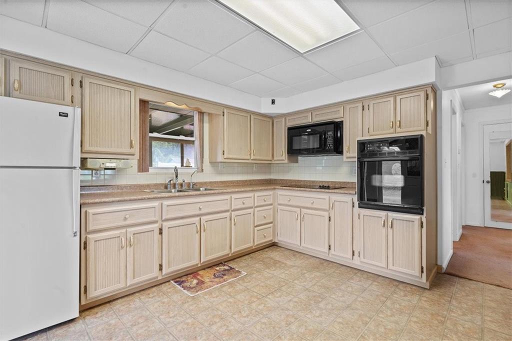 726 Winfield Road Cabot, PA 16023 - Photo 7 of 25 a kitchen with stainless steel appliances granite countertop a refrigerator sink and cabinets