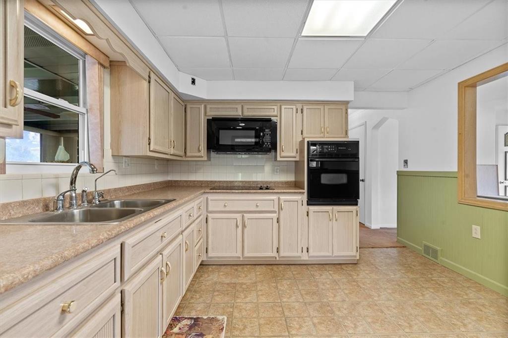 726 Winfield Road Cabot, PA 16023 - Photo 8 of 25 a kitchen with stainless steel appliances granite countertop a stove a sink and a microwave