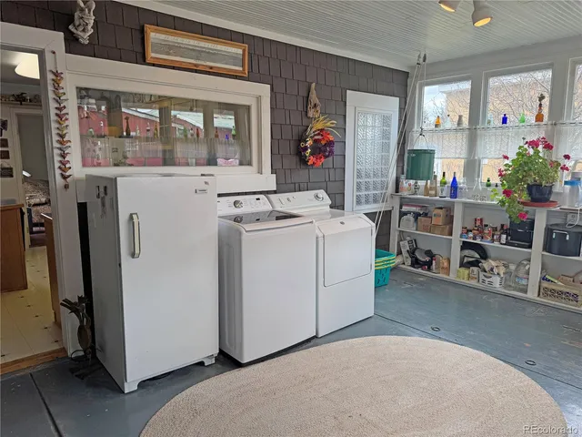 a living room with furniture a flat screen tv and a window