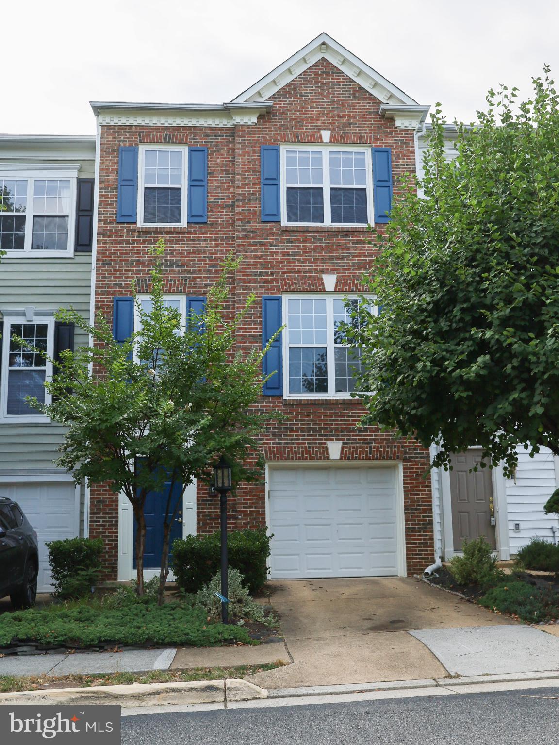 6324 Locust Tree Lane Alexandria, VA 22312 - Photo 1 of 21 a front view of a house with a yard and garage
