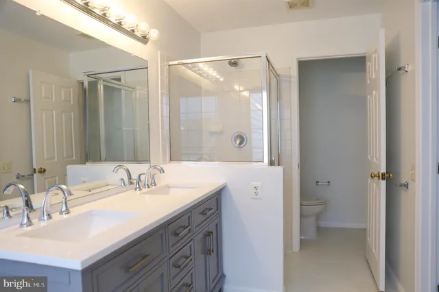 a bathroom with a double vanity sink mirror and double