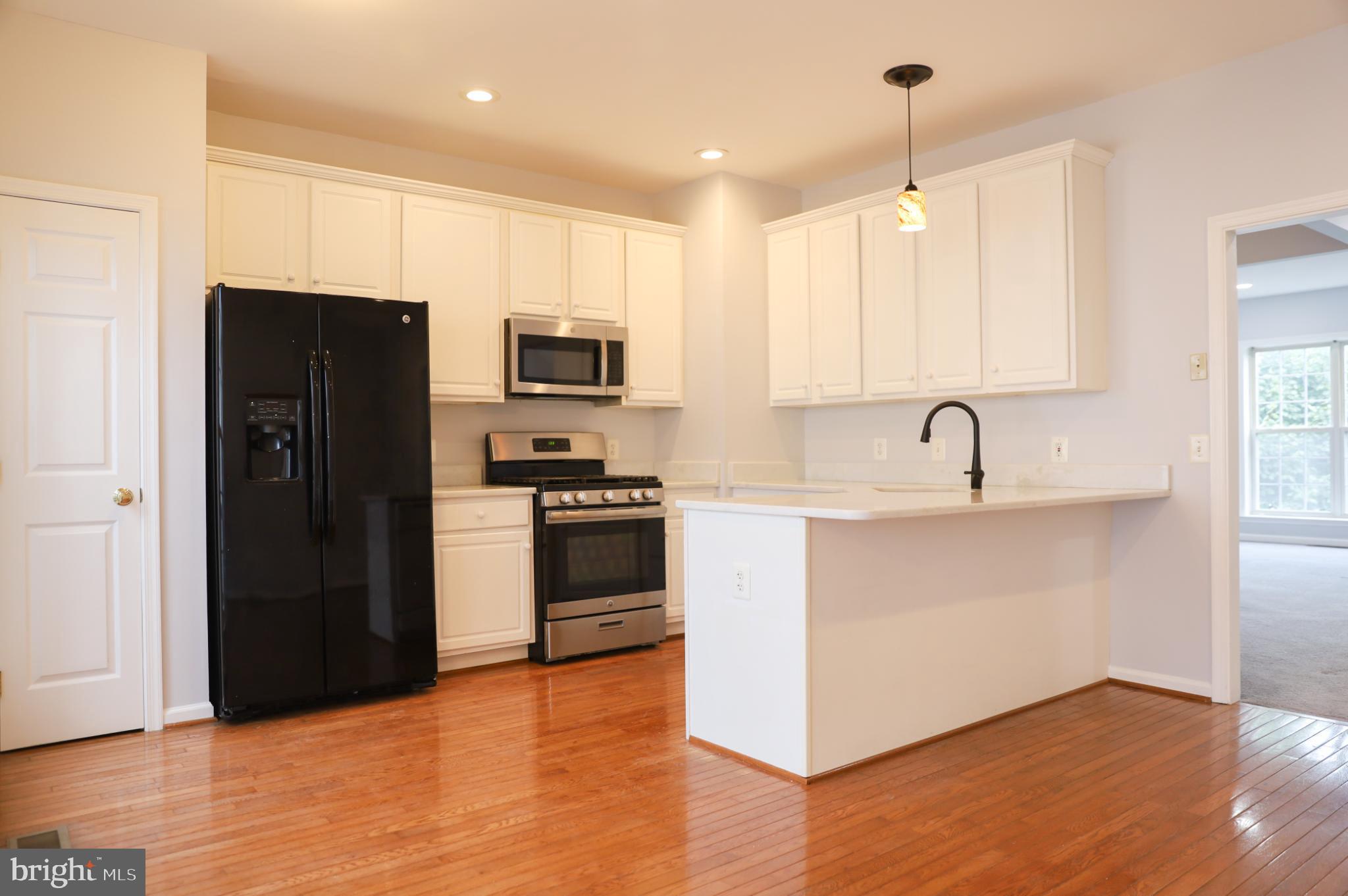6324 Locust Tree Lane Alexandria, VA 22312 - Photo 3 of 21 a kitchen with stainless steel appliances a refrigerator stove and sink