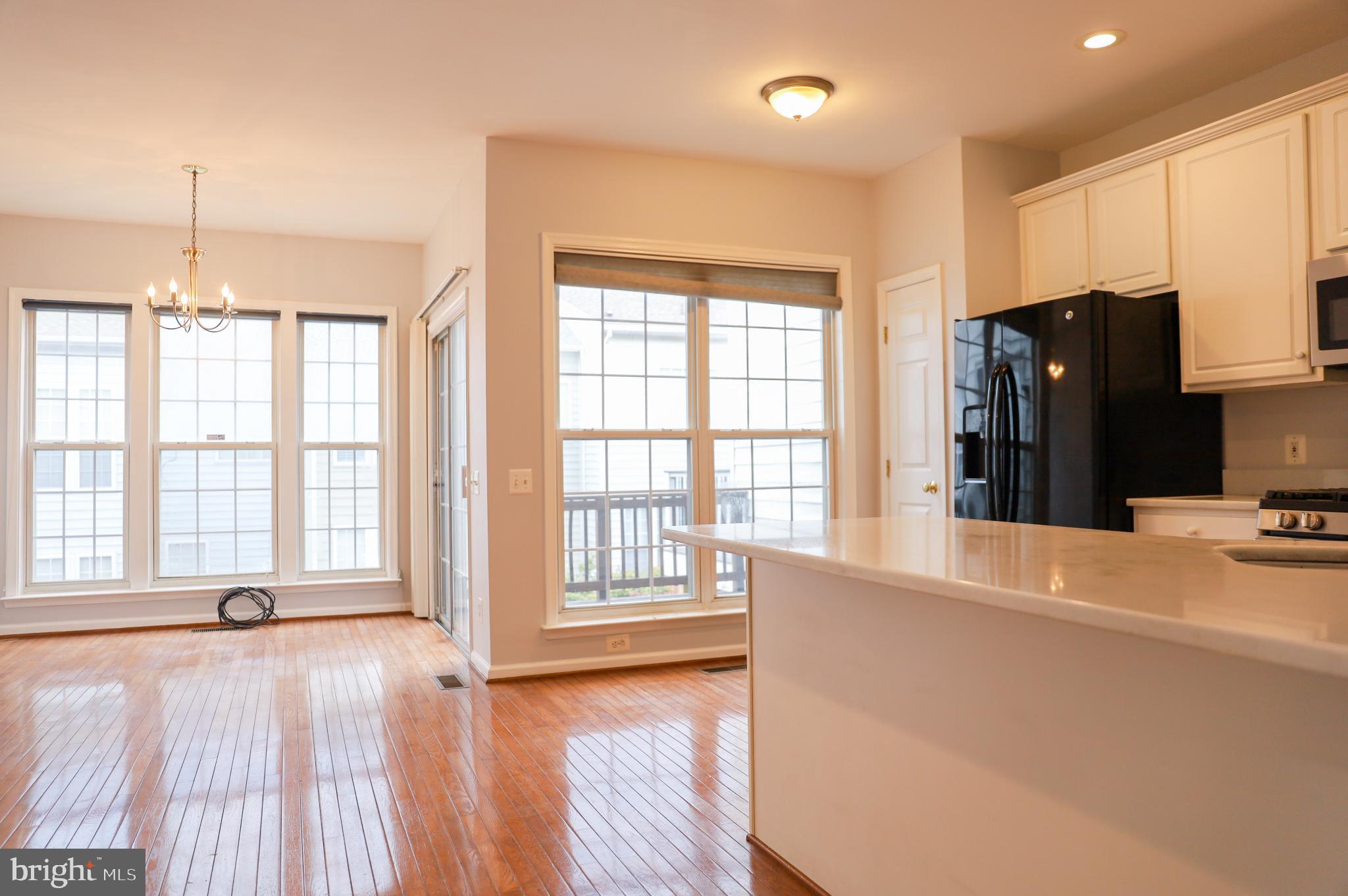 6324 Locust Tree Lane Alexandria, VA 22312 - Photo 4 of 21 a view of an empty room with a window and wooden floor