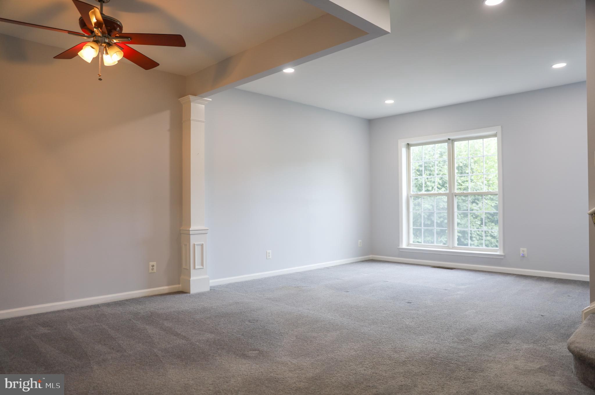 6324 Locust Tree Lane Alexandria, VA 22312 - Photo 8 of 21 en empty room with windows and fan