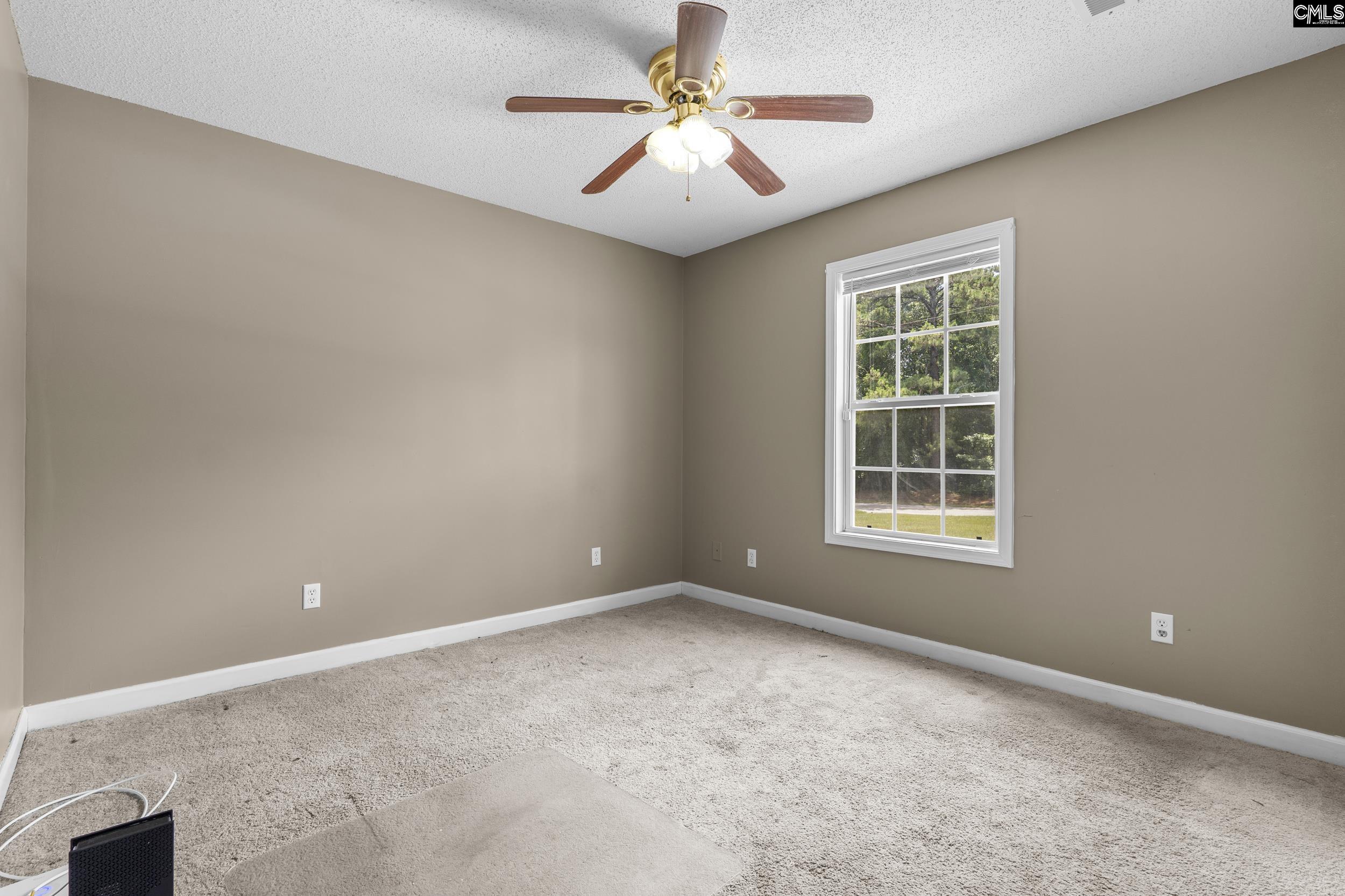 548 Eskie Dixon Road Elgin, SC 29045 - Photo 17 of 27 an empty room with windows and fan