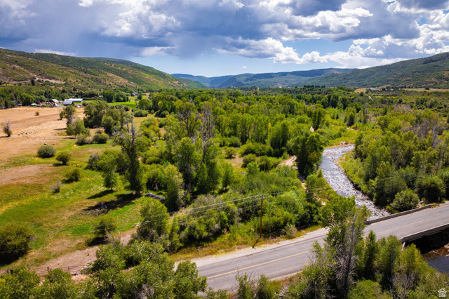 4347 South Bench Creek Road Kamas, UT 84036 - Photo 5 of 30 Expansive natural landscape featuring a winding river, mature trees, open fields, and distant hillsides