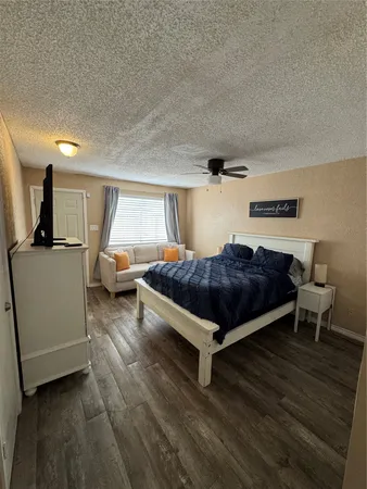 a bedroom with a bed and a chair