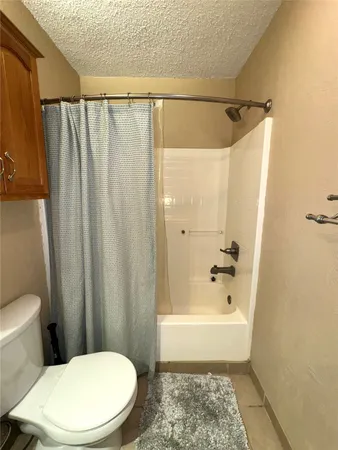 a bathroom with a shower and a toilet