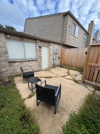 a backyard of a house with table and chairs