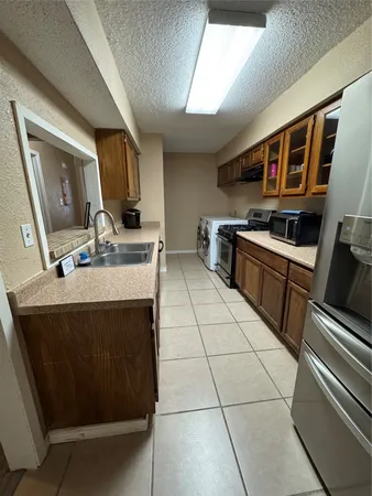 a kitchen with stainless steel appliances a stove a sink and a microwave