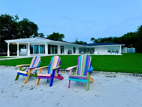 a view of a house with a backyard and a slide