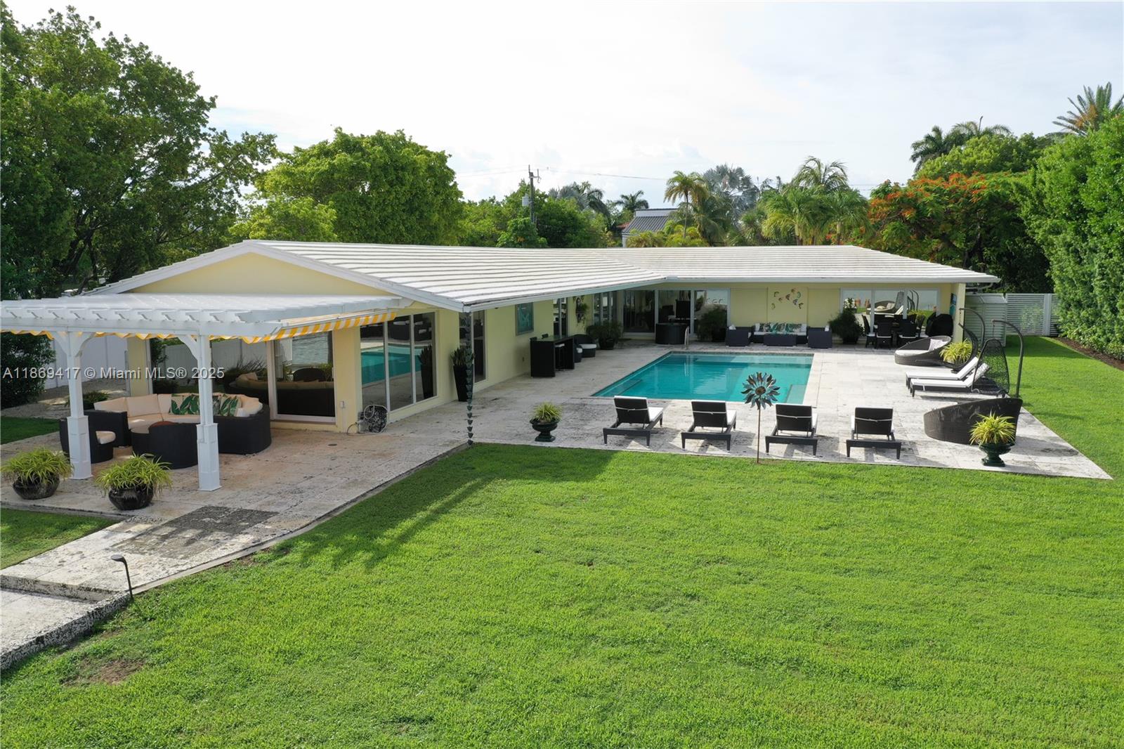 200 Harbor Drive Key Biscayne, FL 33149 - Photo 12 of 24 a view of a patio with table and chairs under an umbrella