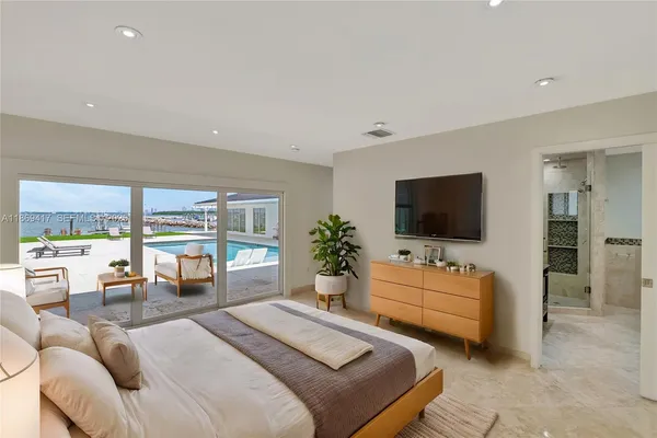 a bedroom with furniture and a flat screen tv