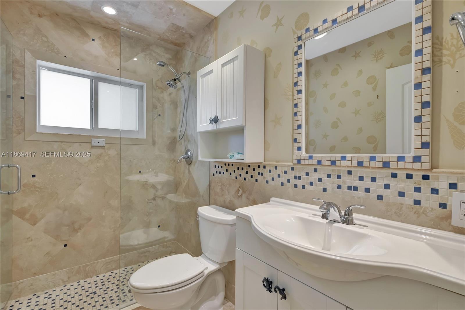 200 Harbor Drive Key Biscayne, FL 33149 - Photo 20 of 24 a bathroom with a sink a toilet and shower
