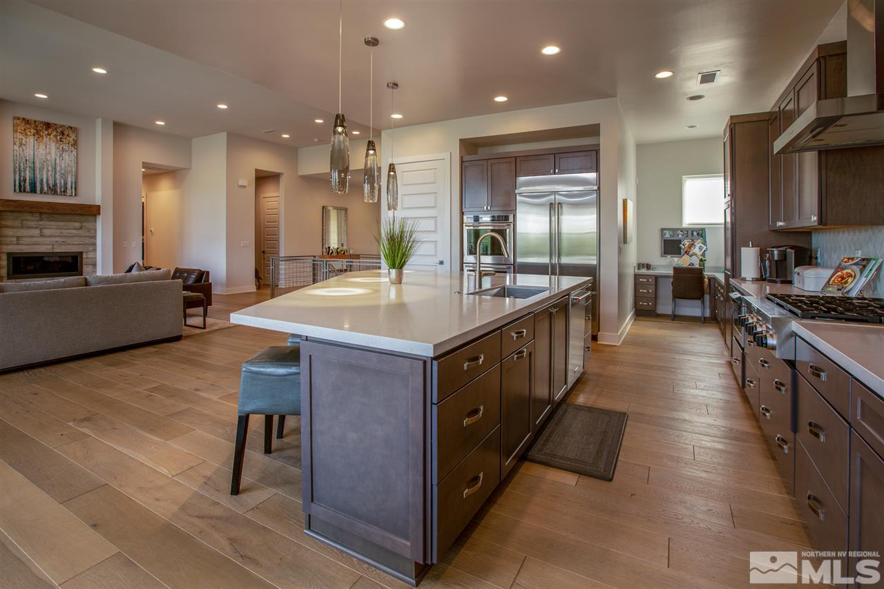 4105 Whispering Pine Loop Reno, NV 89519 - Photo 8 of 35 a kitchen with kitchen island granite countertop lots of counter top space and stainless steel appliances