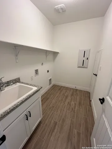 a view of a utility room with wooden floor