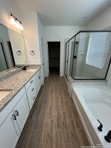 a bathroom with a granite countertop sink a vanity and mirror