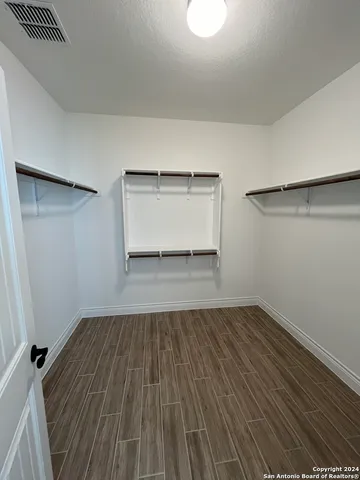 a view of a room with wooden floor and a window
