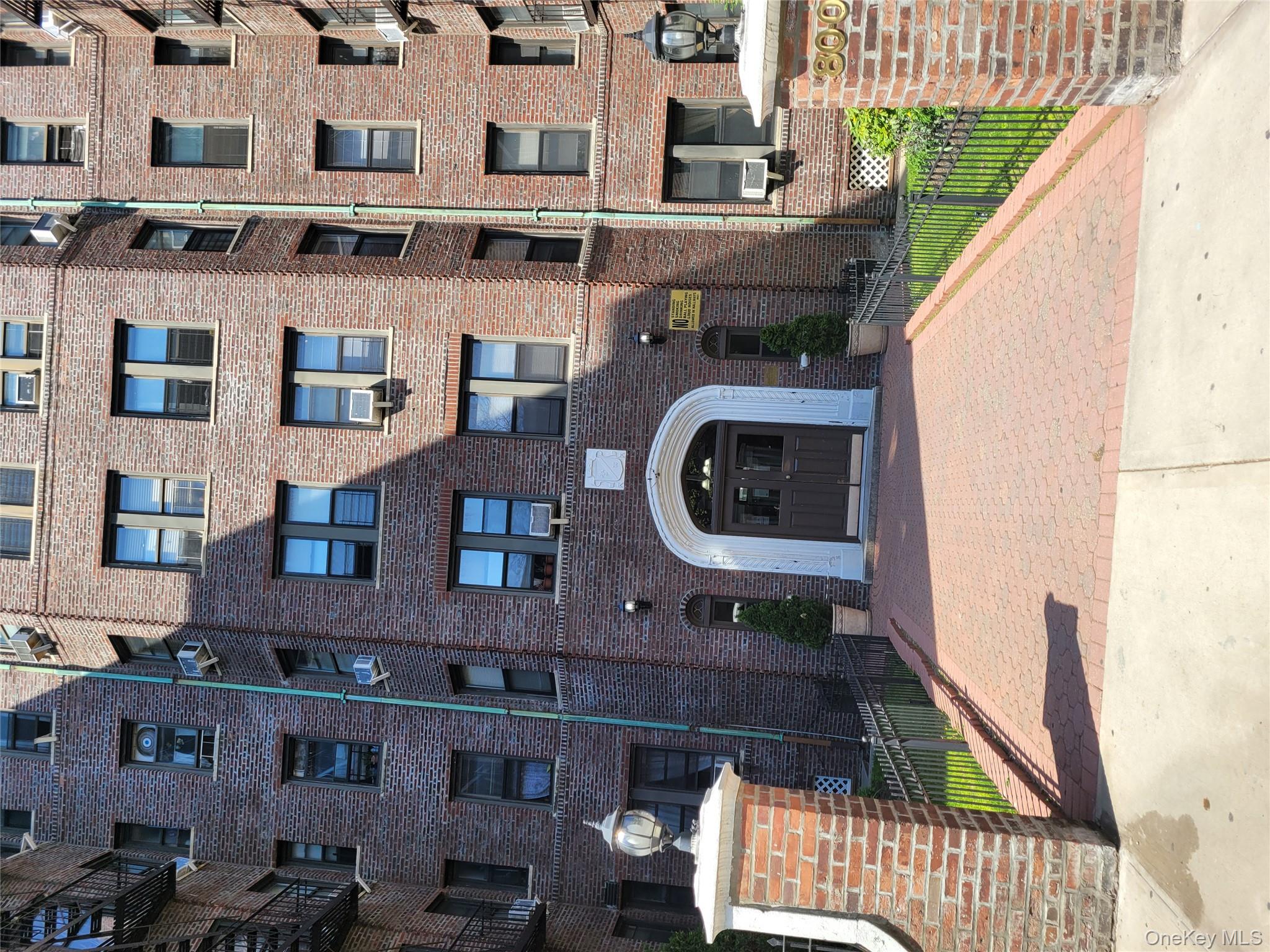 a front view of a brick building with many windows