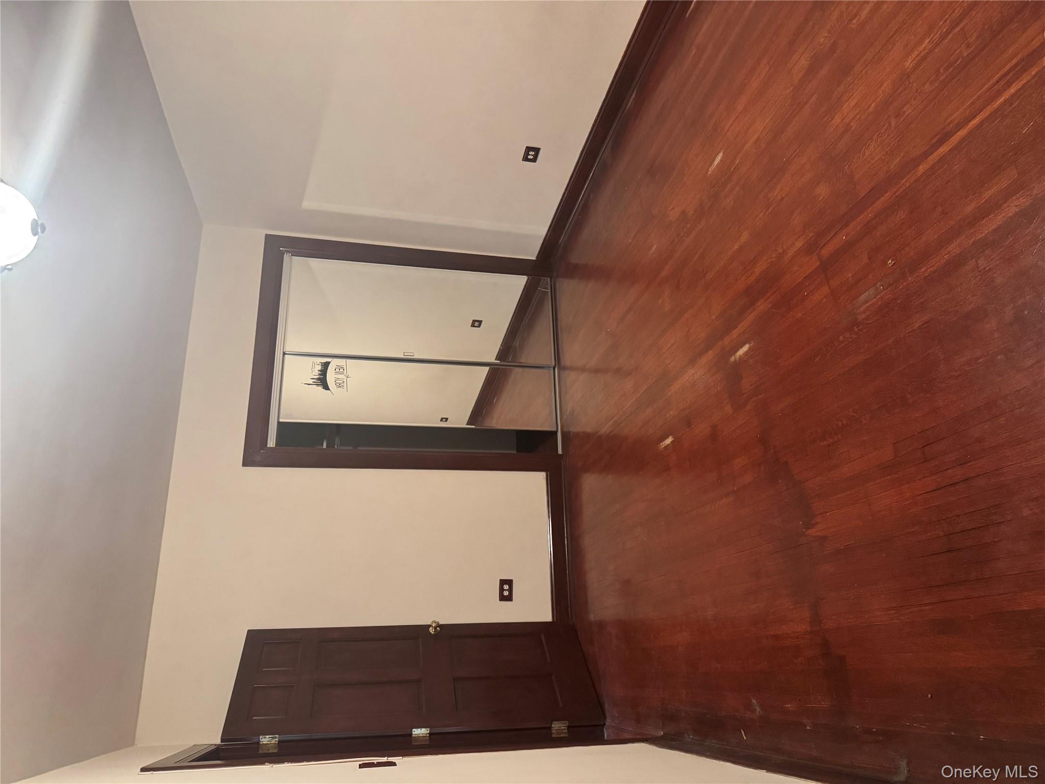 80-09 35th Avenue, Unit A12 Queens, NY 11372 - Photo 16 of 22 a view of an empty room with wooden floor and closet