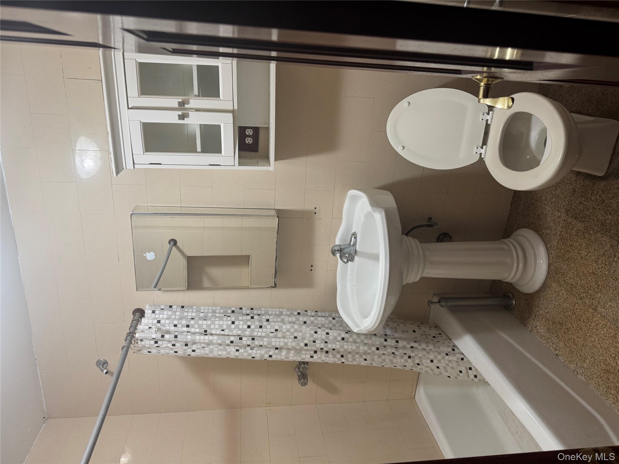 80-09 35th Avenue, Unit A12 Queens, NY 11372 - Photo 18 of 22 a bathroom with a sink toilet and shower