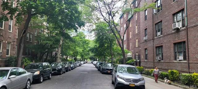a view of a patio with couches and a fire pit and a large tree