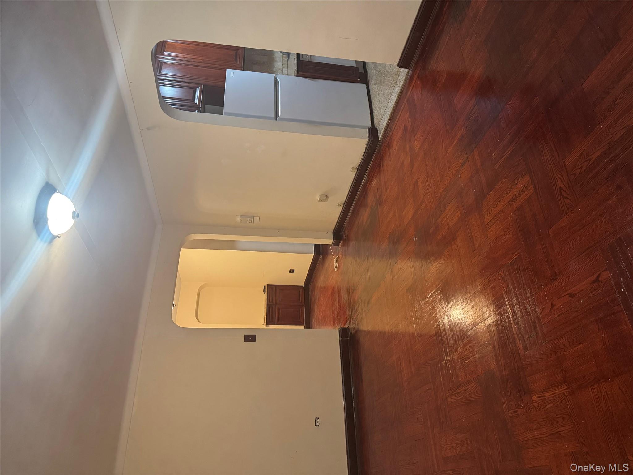 80-09 35th Avenue, Unit A12 Queens, NY 11372 - Photo 9 of 22 an empty room with wooden floor and windows