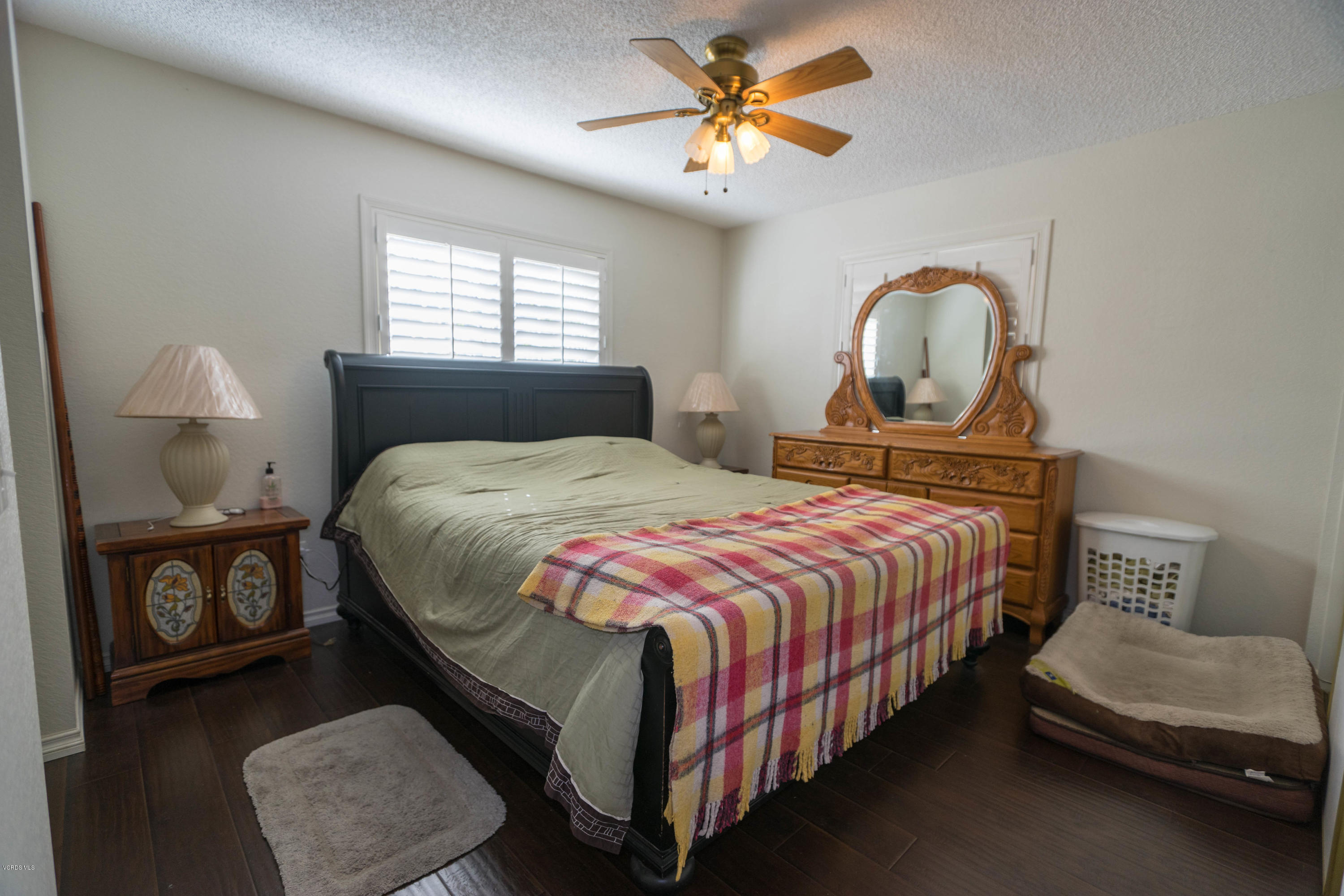 1055 Waltham Road, Unit D Simi Valley, CA 93065 - Photo 8 of 13 a bedroom with a bed and a chandelier