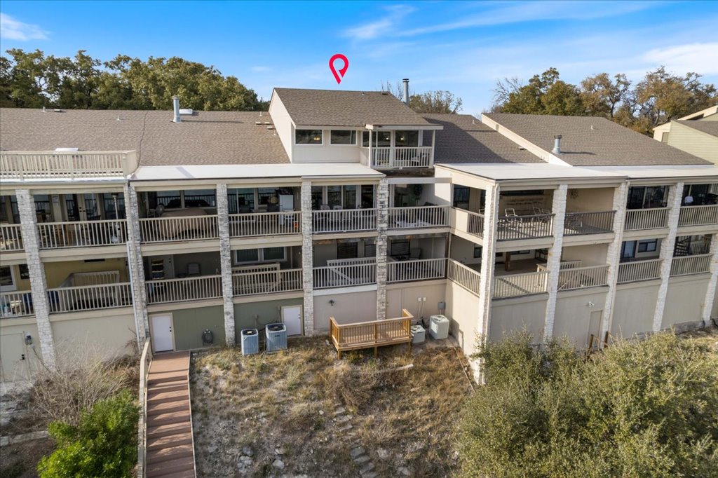 18231 Lakepoint Cove Lago Vista, TX 78645 - Photo 22 of 39 a front view of a house with a yard and balcony