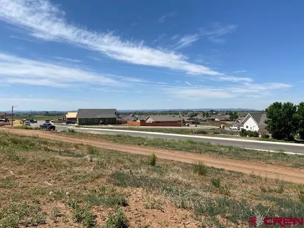 a view of a lake with houses in back